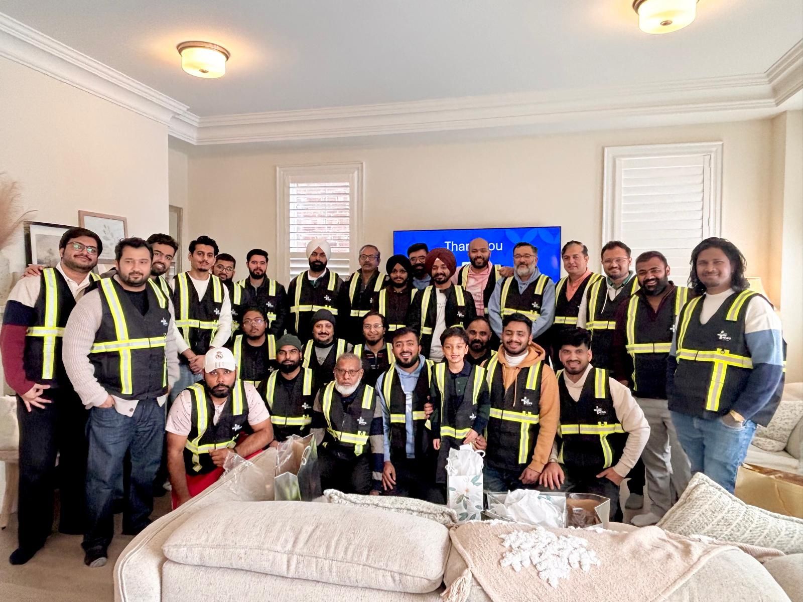 The MWS Care Services delivery team together in high-visibility vests at a company gathering